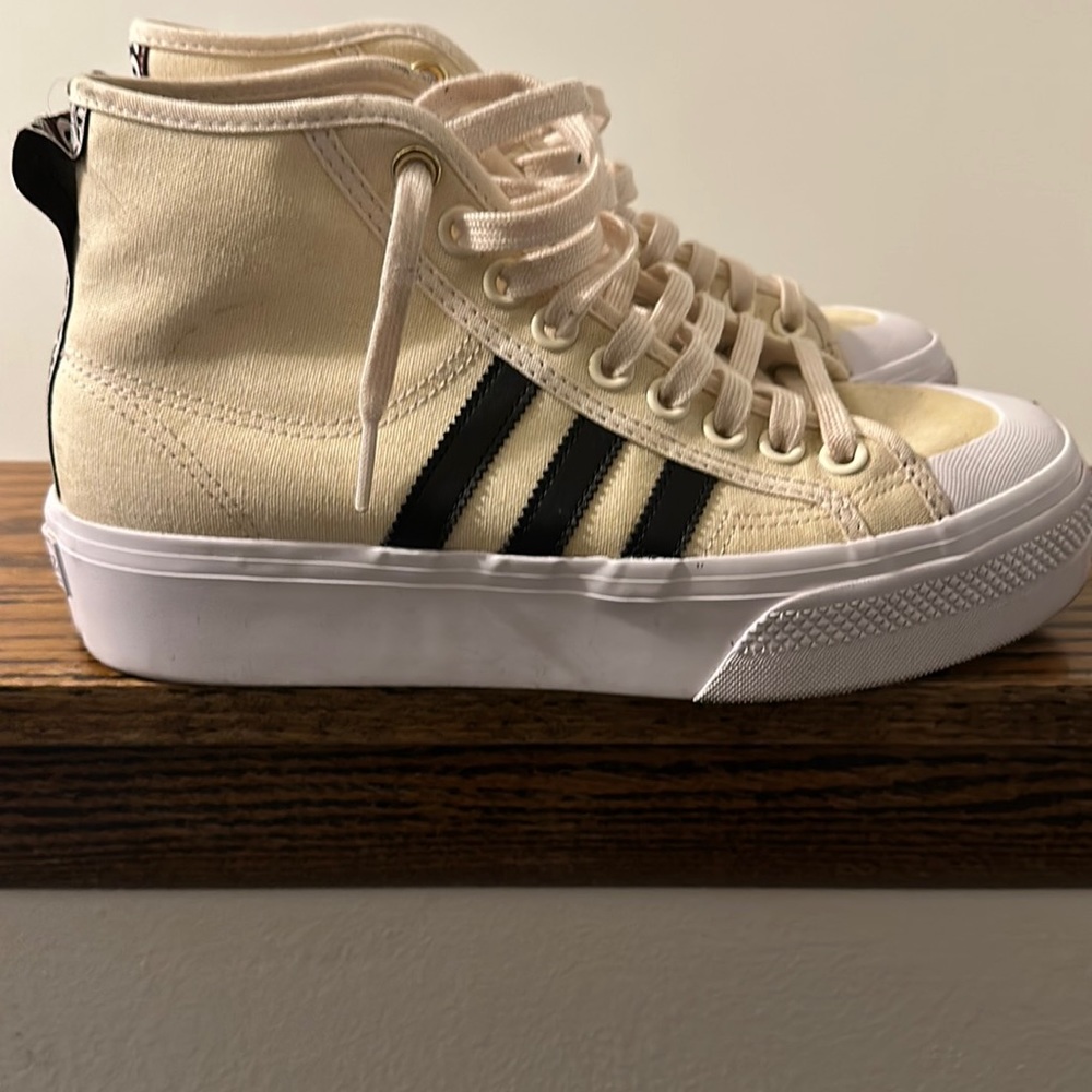 Tan and black high top Nizza adidas shoes